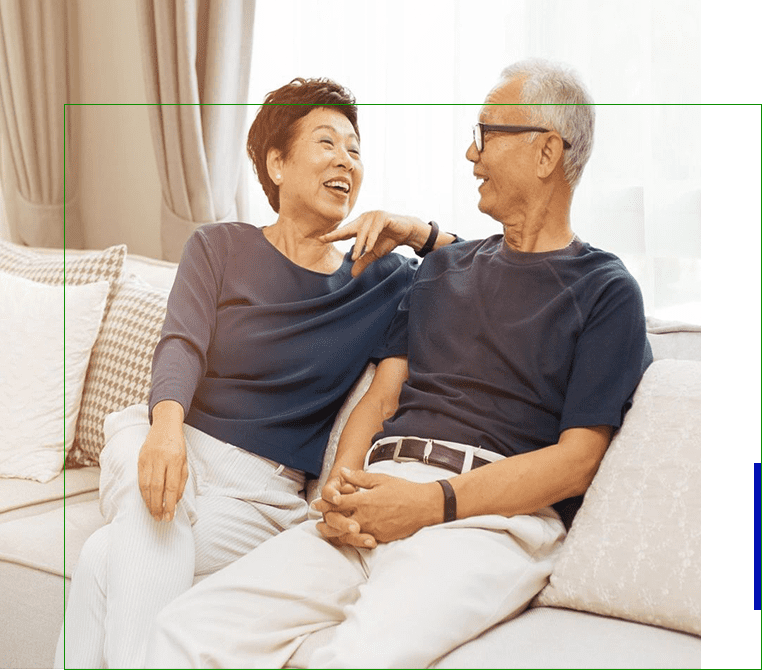 A couple of people sitting on top of a couch.